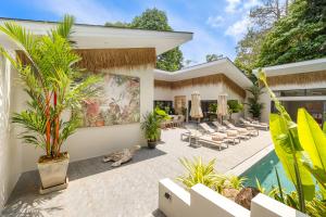an exterior view of a house with a swimming pool at VILLA LOUMA - 4 Bedrooms with Private Pool in Koh Samui