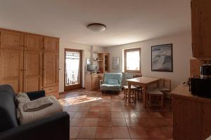 a living room with a couch and a table at Case Gran Paradiso Rhemes Notre Dame in Rhêmes-Notre-Dame