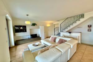 a living room with a couch and a staircase at Villa Aurelia in Plesio