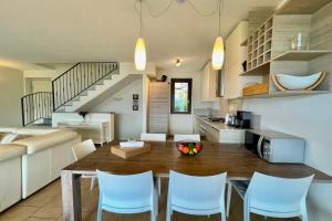 a kitchen and living room with a table and chairs at Villa Aurelia in Plesio +27 photos