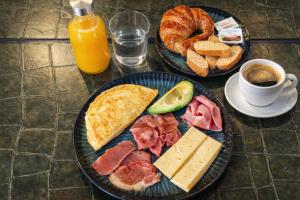 two plates of food on a table with bread and pastries at Hotel Ramblas Internacional in Barcelona +22 photos
