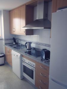 a kitchen with a stove and a white refrigerator at 2108-Nice apt with pool close from beach and bars in Manilva