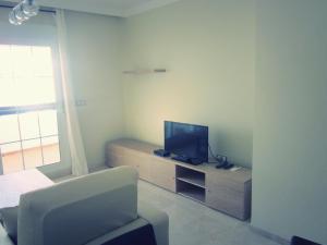 a living room with a tv and a chair at 2108-Nice apt with pool close from beach and bars in Manilva