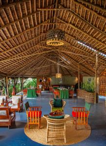 a room with chairs and tables and a large ceiling at Kutoka Lodge in Arusha