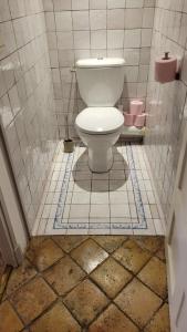 a bathroom with a toilet in a tiled floor at Bed and Breakfast Jardin de Marie in Aix-en-Provence