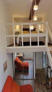 a loft bed in a room with a bedroom at Bed and Breakfast Jardin de Marie in Aix-en-Provence