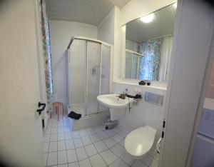 a bathroom with a sink and a shower and a toilet at Hotel Elisenhof in Chemnitz +30 photos