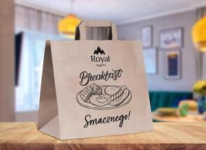 a paper bag with a sandwich on a table at Mountain Horizon Valley z basenami, saunami i strefą fitness by Royal Aparts in Szklarska Poręba +24 photos
