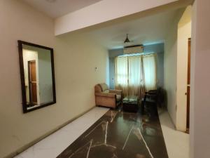 a living room with a couch and a mirror at Hotel The Star in Kālundri