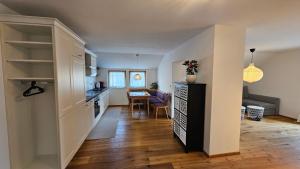 a kitchen and a living room with a table at SCHWEIZER Hof in Tamsweg