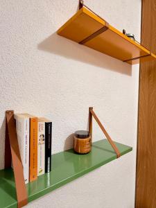 a shelf with books and a cup on it at Incentro in Grosio