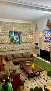 a living room with a couch and a table at Riad d'exception vue mer au coeur de la médina Essaouira - Mandji Dream in Essaouira +44 photos