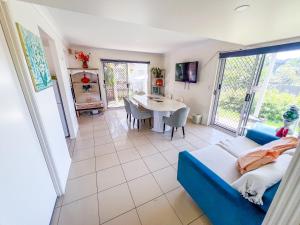 a living room with a blue couch and a table at Vista Air conditioned Holiday Dream Castle Youth Hotel in Brisbane