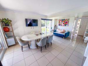 a kitchen and living room with a table and chairs at Vista Air conditioned Holiday Dream Castle Youth Hotel in Brisbane