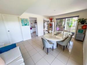 a kitchen and dining room with a table and chairs at Vista Air conditioned Holiday Dream Castle Youth Hotel in Brisbane