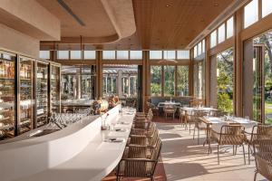 a restaurant with tables and chairs and windows at AKKA Hotels Antedon - Premium All Inclusive in Beldibi