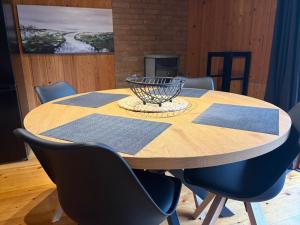 a wooden table with chairs and a bowl on top at Haus Sommerfeld in Meißendorf +9 photos