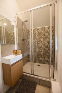a bathroom with a shower and a sink at Villa Athena in Assesse