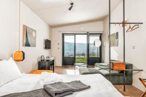 a bedroom with a bed and a living room at Salcheto WineHouse in Montepulciano