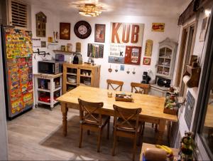 a kitchen with a wooden table and chairs at Un coin de paradis in Oullins