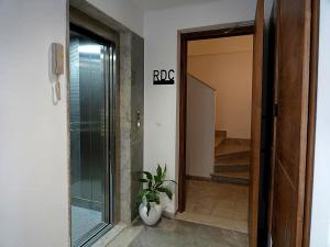 a hallway with a door and a potted plant in a room at Le bleu Turquoise in Sfax