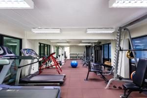 a gym with several treadmills and a blue ball at Annex Lumpini Bangkok in Bangkok
