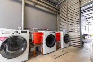 a group of washing machines in a laundry room at Annex Lumpini Bangkok in Bangkok