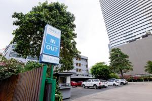a sign that reads in out in a parking lot at Annex Lumpini Bangkok in Bangkok