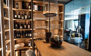 a room with a wall of wine bottles at Paradise Lodge in Livigno