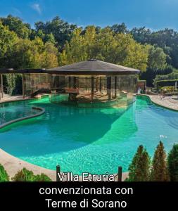 a large swimming pool with a gazebo at Villa Etruria Guest House in Pitigliano