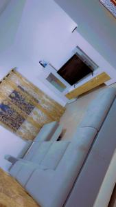 a living room with a couch and a table at A & A Apartments in Serekunda