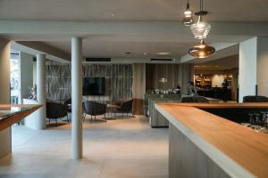 a lobby with a bar and a dining area at Hotel Alpenrose in Schenna