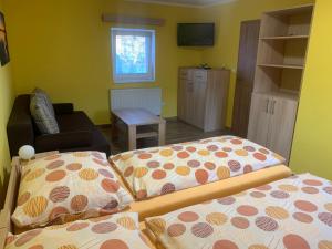 a living room with two beds and a couch at Apartmány Vinařství Tesařík in Prušánky