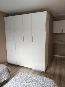 a large white closet in a bedroom with a bed at AMASHIYA flats in Richards Bay