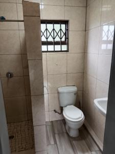 a bathroom with a toilet and a sink at AMASHIYA flats in Richards Bay