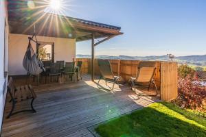 a deck with a table and chairs on it at Place 4you in Grafenau