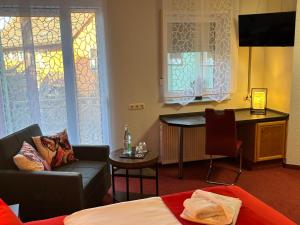 a living room with a couch and a table at Ambiente Hotel Strehla in Strehla