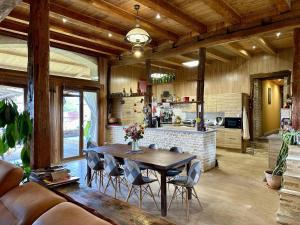 a kitchen and dining room with a table and chairs at La Ferme de Tart in Verdonnet