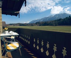 a balcony with a table and a view of a mountain at Kleinreiterhof Ferienwohnungen Limmer in Bad Reichenhall