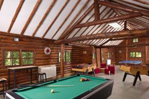 a room with a pool table in a building at Hôtel Centre Port-Royal in Saint-Lambert