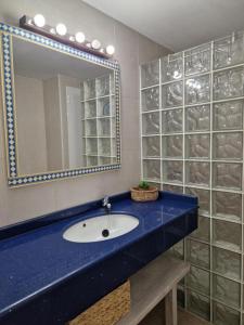 a bathroom with a sink and a mirror at Mirada Ponent in Es Pujols +8 photos