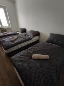 two beds in a room with two towels on them at Central Apartman Tatabánya in Tatabánya