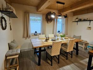 a dining room with a wooden table and chairs at Chalupa uprostred niceho in Hlinsko