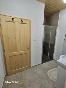 a bathroom with a wooden door with stars on it at Chalupa uprostred niceho in Hlinsko +16 photos