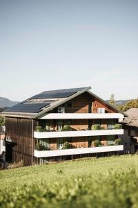 a house with solar panels on the roof at La Paula Apartments & Suites in Siusi
