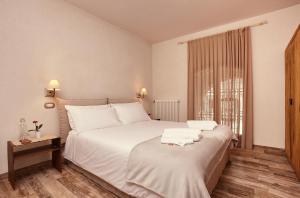 a bedroom with a white bed with towels on it at B&B Il Vicoletto in Santarcangelo di Romagna