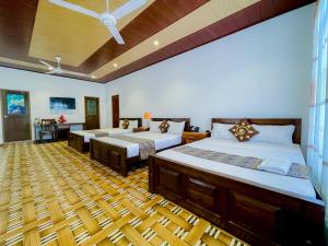 a bedroom with two beds and a wooden floor at Yaalu-Yaalu in Welikanda +12 photos