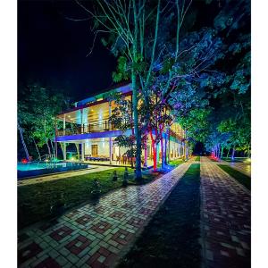 a building with colorful lights on a street at night at Yaalu-Yaalu in Welikanda