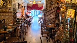 a room with tables and chairs in a restaurant at Hotel Mozart in Brussels
