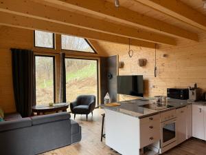 a kitchen and living room with a couch and a table at Chata Przesieka in Przesieka